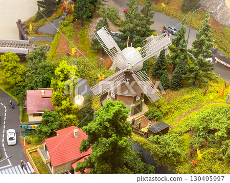 A miniature model shows suburban houses, cars, and people on streets with greenery. Architecture, community, and transportation represent urban lifestyle, culture, and everyday neighborhood life. A miniature model shows suburban houses, cars, and people on streets with greenery. Architecture, community, and transportation represent urban lifestyle, culture, and everyday neighborhood life. 130495997