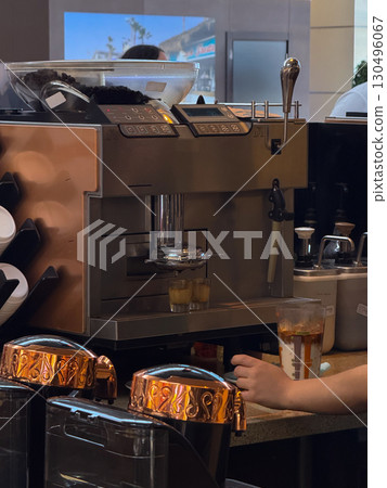 Professional coffee machine preparing espresso shots. Beverage preparation, hospitality and modern cafe service. 130496067