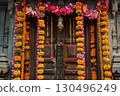 Traditional Indian entrance door beautifully decorated with vibrant marigold flower garlands and lotus blossoms for a festive celebration. Perfect for Diwali or wedding decor inspiration 130496249