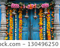 Festive Indian blue doorway decorated with colorful garlands of marigold and lotus flowers symbolizing warmth, prosperity and tradition during cultural or religious festivals of Diwali or wedding. 130496250