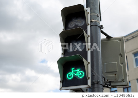 Green bicycle signal light showing go, indicating safe passage for cyclists. Symbolizing modern urban mobility and growing importance of bicycle infrastructure for eco friendly transportation Green bicycle signal light showing go, indicating safe passage for cyclists. Symbolizing modern urban mobility and growing importance of bicycle infrastructure for eco friendly transportation 130496632