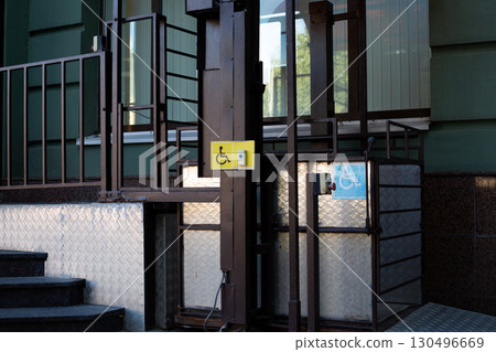 Platform lift offers convenient and accessible movement for wheelchair users, ensuring equal access to buildings and improving urban mobility for people with disabilities 130496669