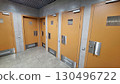 Public restroom interiors with multiple stall doors in modern design 130496722