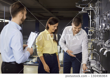 Young family couple shopping for some bathroom fittings at modern home goods store Young family couple shopping for some bathroom fittings at modern home goods store 130496964