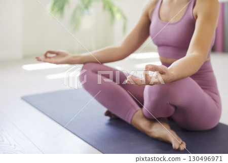 Close-Up Of Woman Meditating In Lotus Pose 130496971