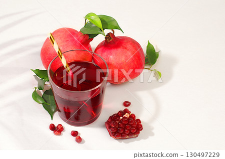 Pomegranate juice drink and ingredients, rich pomegranate drink on elegant sunny table, detox diet and weight loss concept, natural food for healthy lifestyle, source of vitamin C 130497229