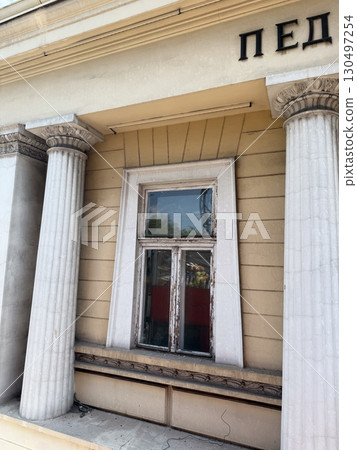 Classical columns supporting facade of an old public building. Architectural tradition, civic identity, and historic symbolism. Classical columns supporting facade of an old public building. Architectural tradition, civic identity, and historic symbolism. 130497254