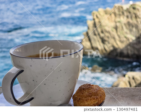 Morning cup of Italian coffee with a picturesque sea view 130497481