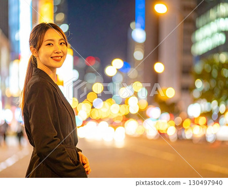 woman walking in the city at night 130497940