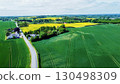 Amazing aerial view on  farm with living hoouse and house garden , surrounding by flowering agricultuiral fields in Denmark (Odense district) 130498309