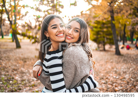 Two Women Hugging Each Other in a Park Two Women Hugging Each Other in a Park 130498595