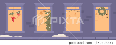 Four illuminated windows with festive Christmas decoration and ornament cute building facade 130498834