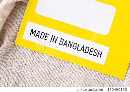 Close up on a label of socks with inscription Made in Bangladesh. Producing clothes in Bangladesh concept Close up on a label of socks with inscription Made in Bangladesh. Producing clothes in Bangladesh concept 130499160