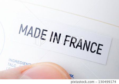 Close up of bottle with inscription Made in France in hands of a man. Production of goods in France concept Close up of bottle with inscription Made in France in hands of a man. Production of goods in France concept 130499174
