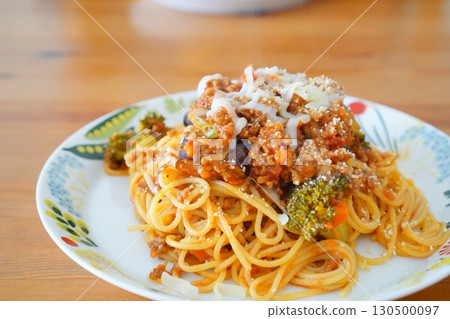 Homemade spaghetti with meat sauce and broccoli and eggplant photographed at the dinner table Homemade spaghetti with meat sauce and broccoli and eggplant photographed at the dinner table 130500097