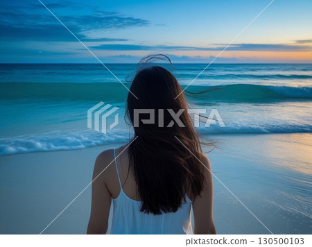 Woman on the beach at sunset Woman on the beach at sunset 130500103