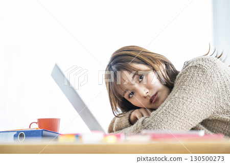Portrait of a young woman teleworking Portrait of a young woman teleworking 130500273