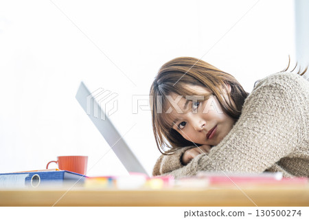 Portrait of a young woman teleworking 130500274
