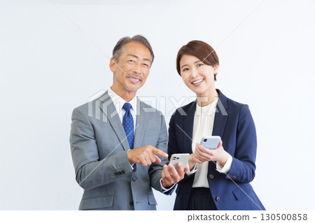 Businessman boss subordinate looking at smartphone 130500858