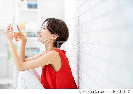 Woman watching video on smartphone 130501307