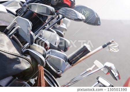 A lot of golf clubs in a cart 130501390