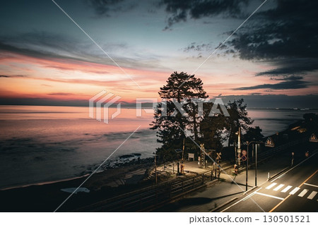 Yoshitsuneiwa railroad crossing during magic hour in Takaoka City Yoshitsuneiwa railroad crossing during magic hour in Takaoka City 130501521