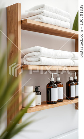 Spa treatment set, wooden shelf with neatly folded towels and dispensers for soap, cream, massage oil 130501838