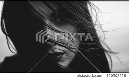 Monochrome portrait of a beautiful woman. Strong wind blows your hair Monochrome portrait of a beautiful woman. Strong wind blows your hair 130502256