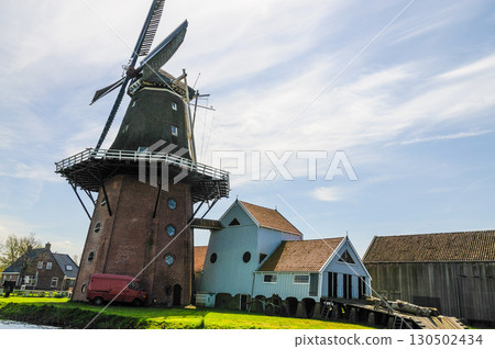 Classic Dutch windmill in a Frisian town. 130502434
