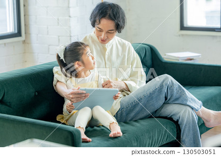Family looking at tablet Family looking at tablet 130503051