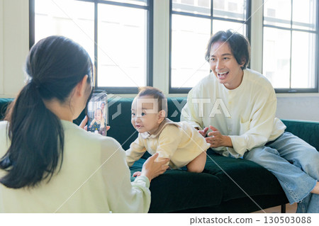 A family taking pictures of their daily lives with a smartphone 130503088