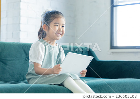 Elementary school student looking at a tablet Elementary school student looking at a tablet 130503108