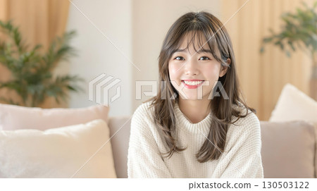 Smiling young woman in the living room 130503122