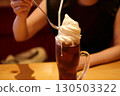 Woman eating a coffee float 130503322