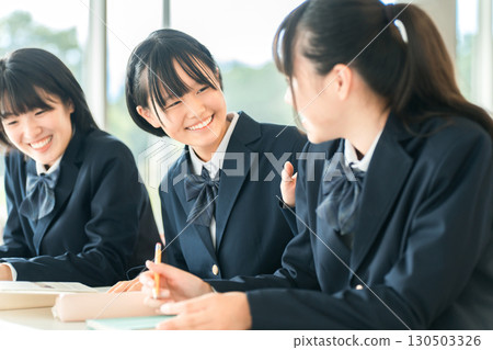 Smiling classmates talking during class, elementary school, junior high school, and high school girls 130503326
