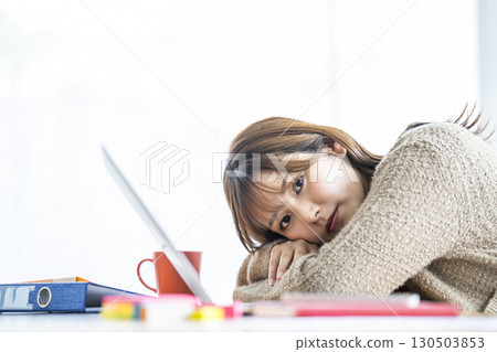 Portrait of a young woman teleworking Portrait of a young woman teleworking 130503853