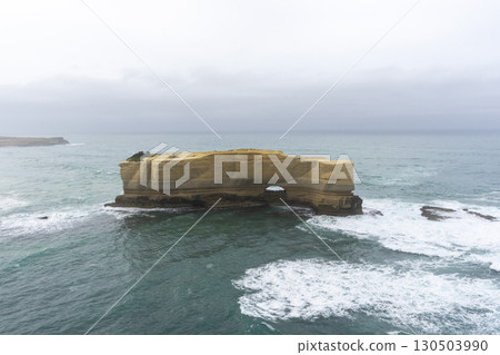 The Bakers Oven so called for the shape of the natural arch in the cliff face. A sea stack on the coast of the Great ocean Road, Australia. The Bakers Oven so called for the shape of the natural arch in the cliff face. A sea stack on the coast of the Great ocean Road, Australia. 130503990