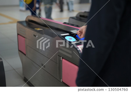 A man passing through the ticket gate A man passing through the ticket gate 130504760