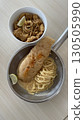 Delicious crispy fish fillet and pasta in a bowl and pan 130505990