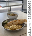 Delicious crispy fish fillet and pasta in a bowl and pan 130506069