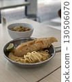 Delicious crispy fish fillet and pasta in a bowl and pan 130506070