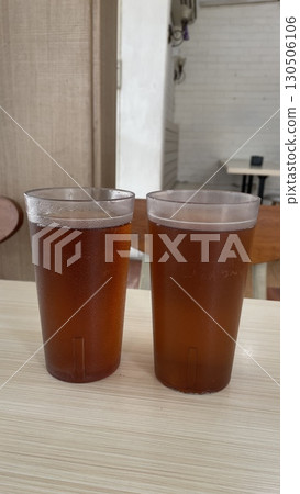 A glass of Ice lemon tea on the wooden table 130506106