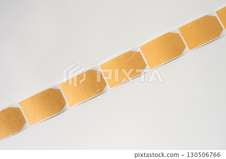 Line of blank brown adhesive labels on white background Line of blank brown adhesive labels on white background 130506766