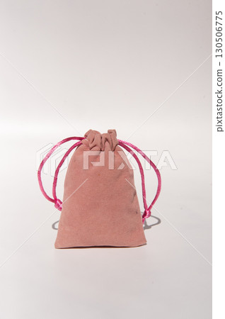Pink fabric drawstring bag on neutral background Pink fabric drawstring bag on neutral background 130506775