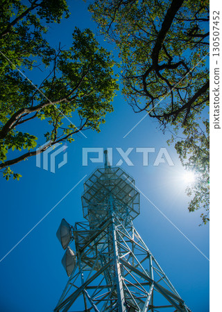 A radio tower with the sun behind it A radio tower with the sun behind it 130507452