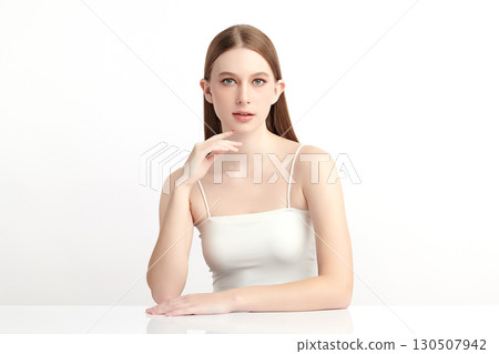 A beautiful young Asian woman with clean, fresh skin against a white background. Skincare, facial treatment, cosmetology, beauty, and spa. An elegant portrait of an Asian woman. 130507942