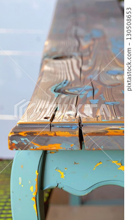 Close Up of Weathered Wooden Table with Blue and Orange Paint Detail Texture 130508653