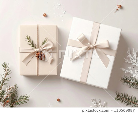 Elegant Beige and White Gift Boxes Decorated with Ribbons and Pine on a White Table 130509097