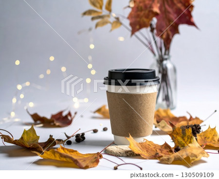 Coffee Cup Surrounded by Autumn Leaves Against Light Background and Glass Vase Coffee Cup Surrounded by Autumn Leaves Against Light Background and Glass Vase 130509109