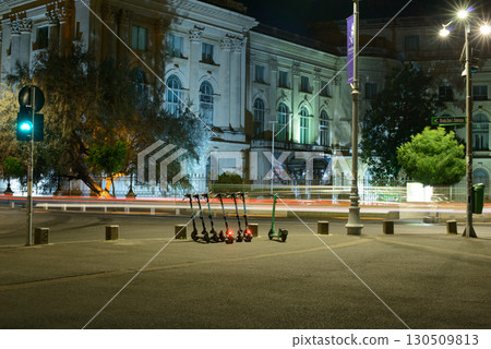 E-Scooters Parked at Night with Light Trails in Bucharest 130509813